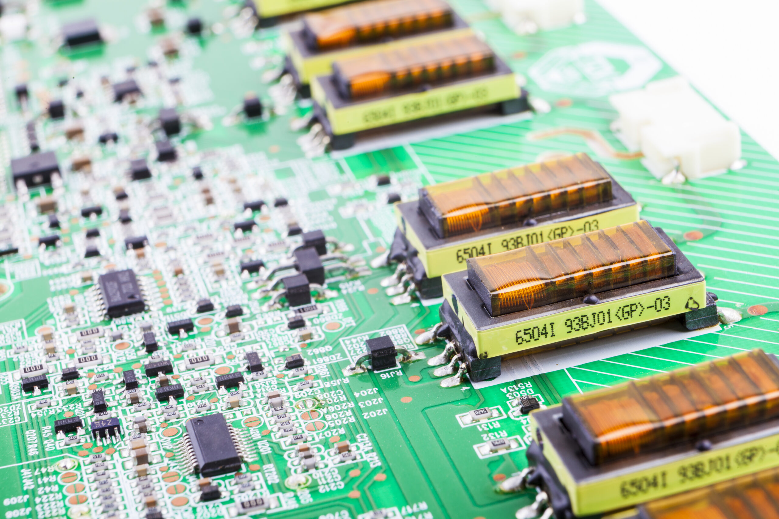 Electronics manufacturing circuit board with components and integrated circuits for cost optimization.
