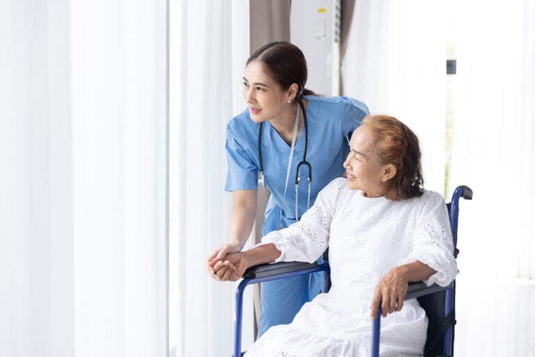 Nurse assisting elderly woman in wheelchair at home, career development for travel nurses