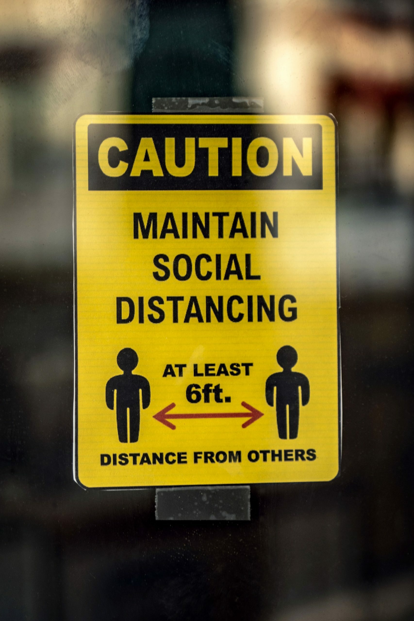 a yellow sign with a black and white label